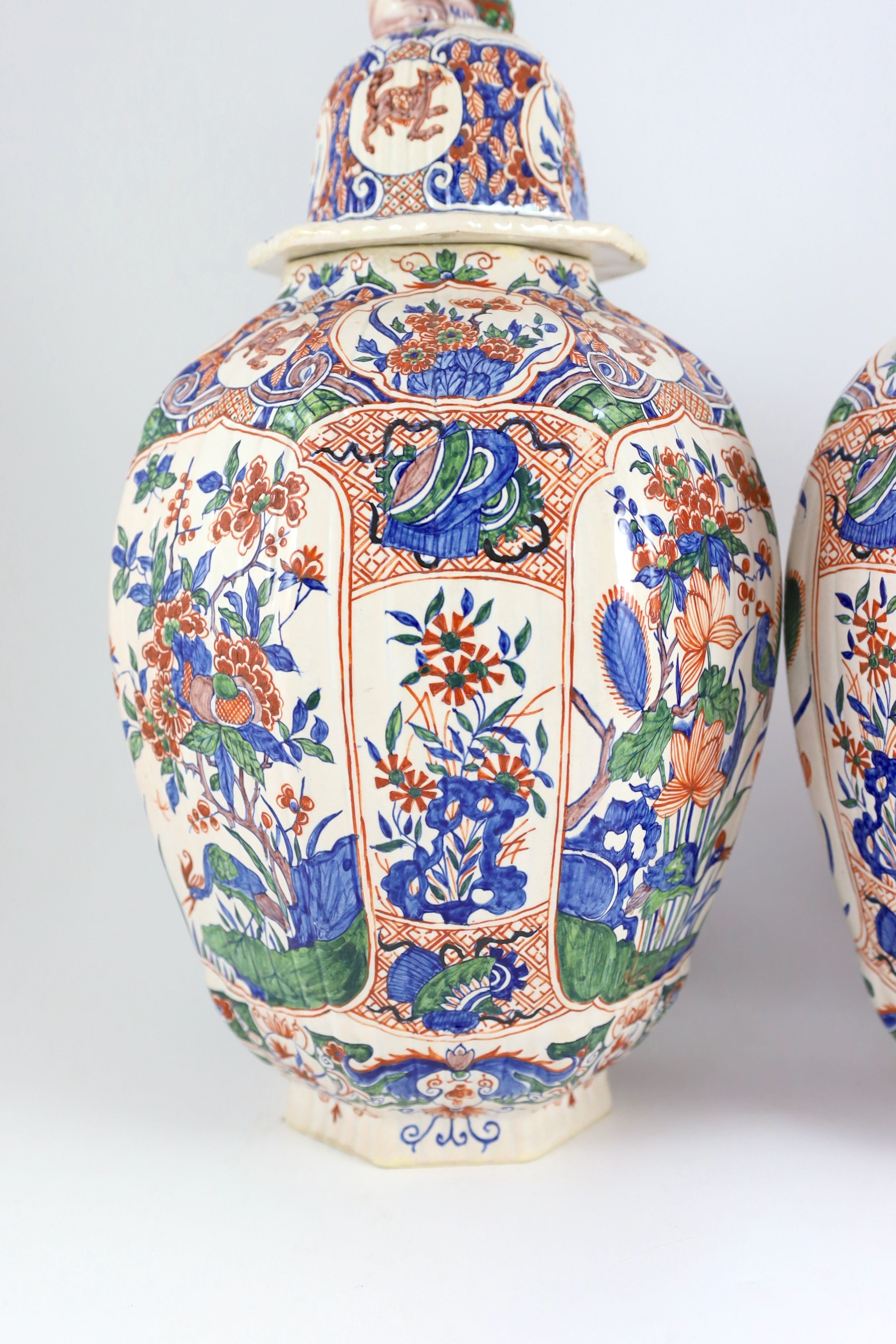 A pair of large Delft jars and covers, Pieter Kocx factory De Grieksche A, c.1701-1722, 50.5cm high, damage to covers